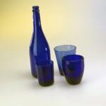 tre bicchieri ed una bottiglia blu suo tavolo da Still life, retro illuminato da due piccoli bank con una gelatina gialla su quello di sinistra e blu su quello di destra